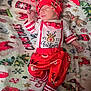 newborn, baby, sleeping, christmas, holiday, pajamas, red_clothing, white_clothing, blanket, reindeer, festive, striped_socks, hat, infant, cute, cozy, holiday_theme, patterned_clothing, lying_down, celebration