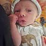 baby, newborn, infant, cute, onesie, hat, animal_print, hand, tattoo, skin, portrait, resting, close_up, person, soft, cozy, warm_colors, expression, face, child