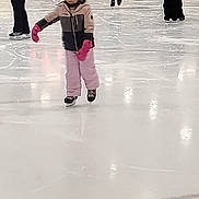 Kassie joined the competition — help win amazing prizes! child, ice_skating, helmet, pink_gloves, winter_clothing, indoor_rink, ice, people, skates, sport, activity, cold_weather, jacket, pants, helmet_strap, skating, recreation, balance, fun, leisure