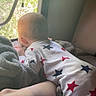 Nova is registered to the contest to win money with this photo: baby, pajamas, stars, blanket, window, indoor, natural_light, curious, child, bed, cozy, soft, relaxing, infant, sleepwear, crawling, home, morning, comfort, rest