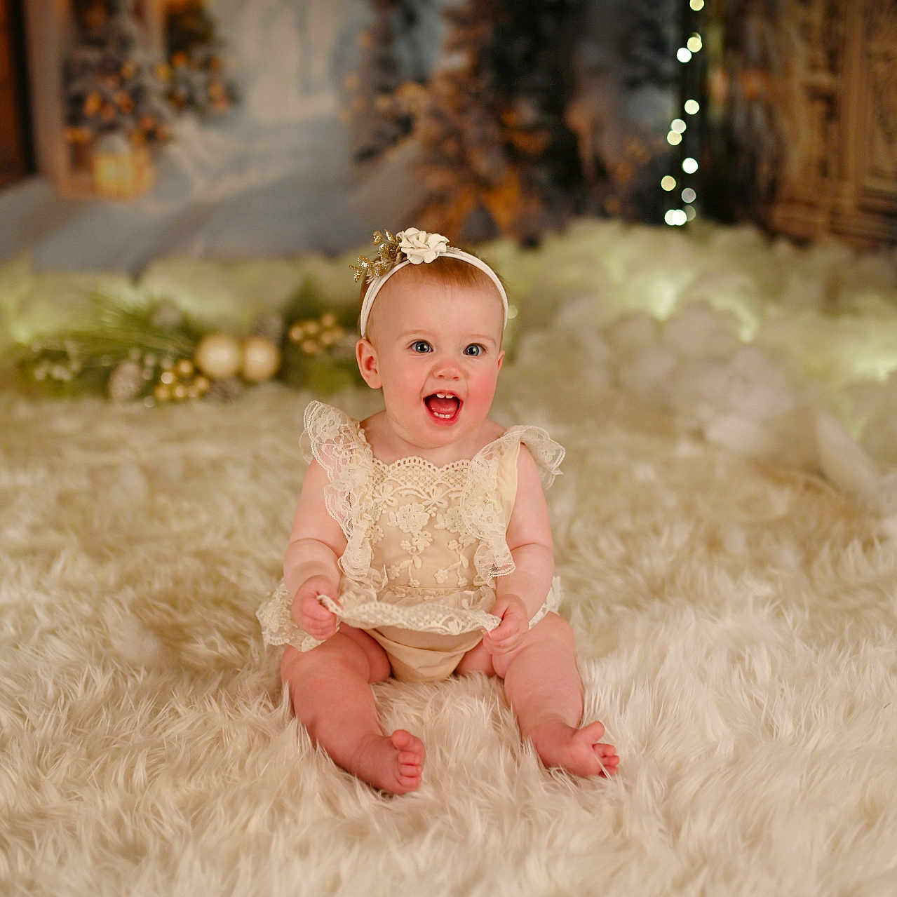 Emma is registered to the contest to win money with this photo: accessories, baby, babylaughing, bodypart, clothing, crawling, dress, face, finger, formalwear, hand, happy, head, jewelry, newborn, person, photography, portrait, sitting, wood