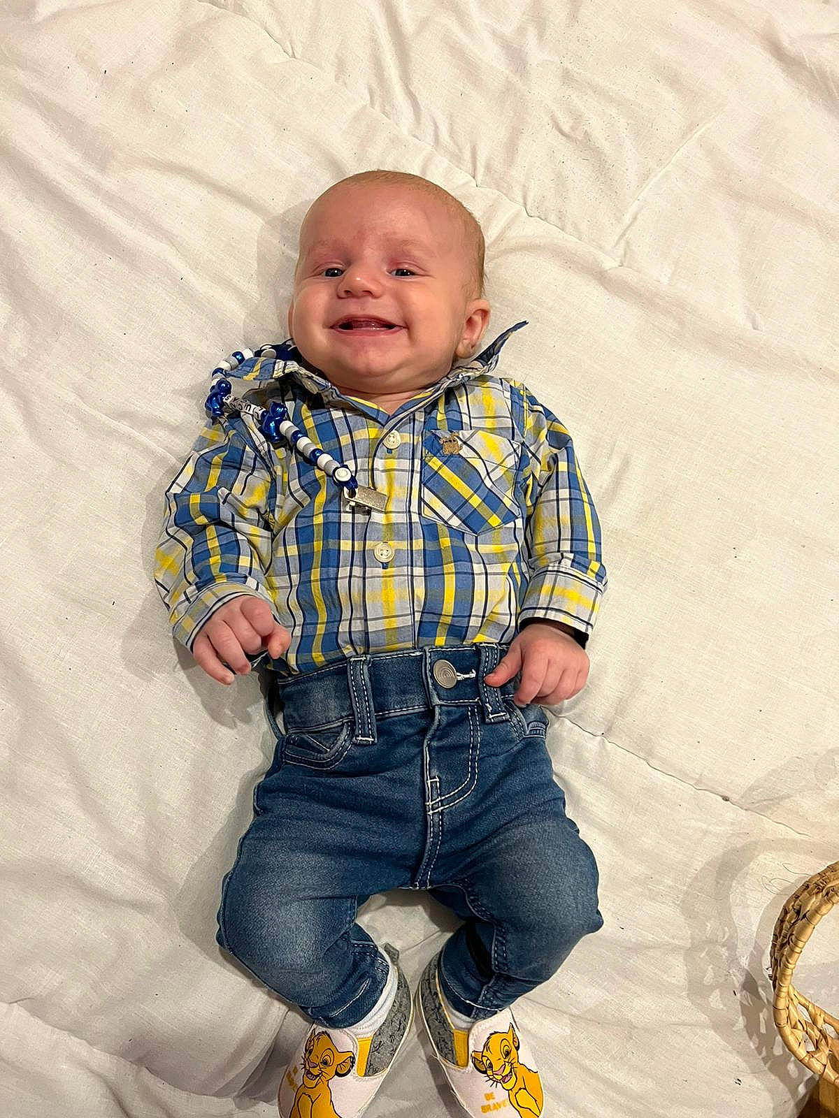 Lucas is registered to the contest to win money with this photo: arm, baby, baby_toddler_clothing, collar, comfort, denim, dress_shirt, eye, face, happy, jeans, joy, outerwear, person, plaid, skin, sleeve, smile, sneakers, tartan