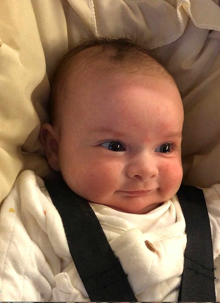 Bonnie is registered to the contest to win money with this photo: baby, infant, face, smile, clothing, straps, blanket, cozy, cute, cheeks, eyes, head, newborn, person, portrait, indoors, soft, expression, sleepwear, child