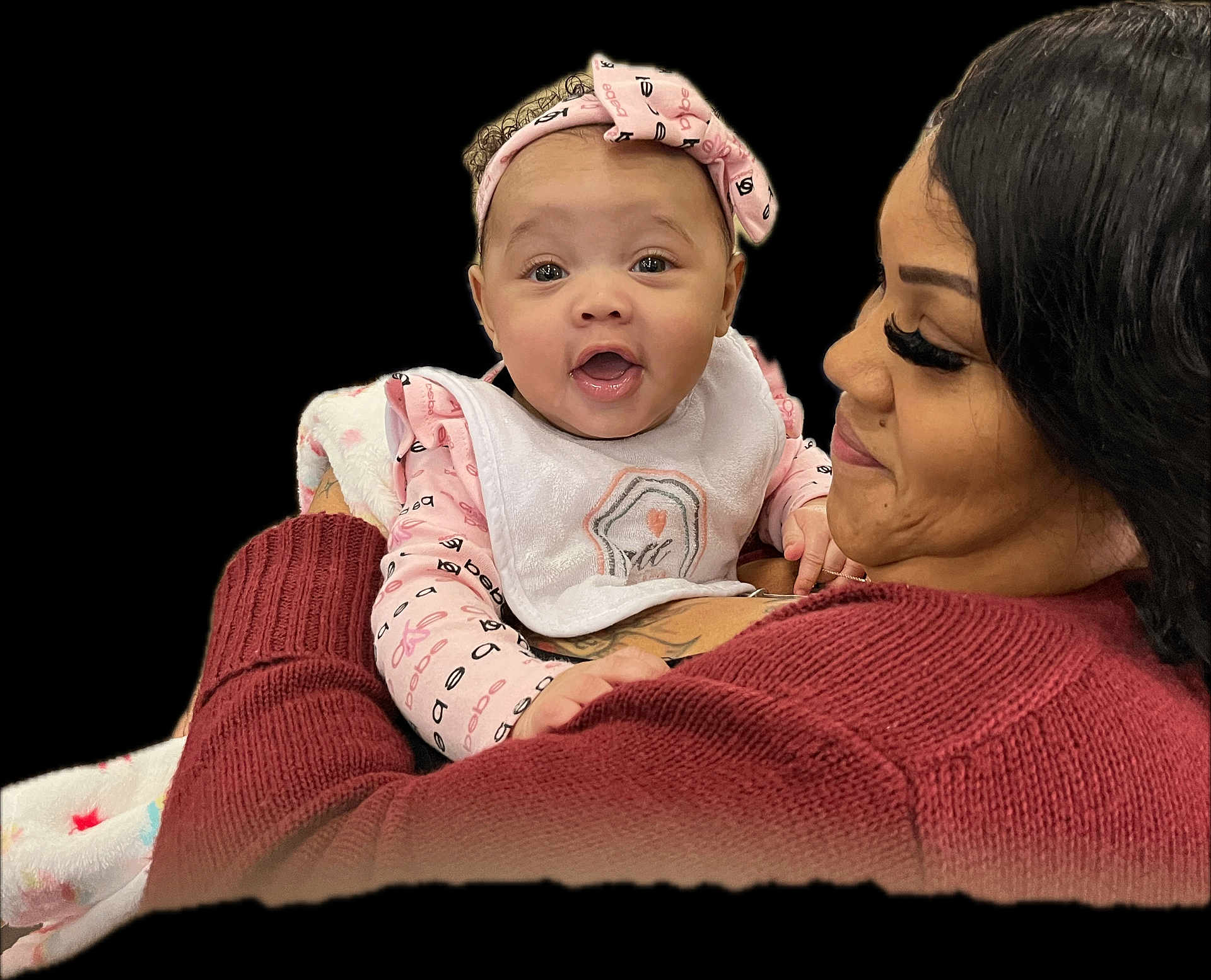 Kalayiah joined the competition — help win amazing prizes! baby, infant, child, woman, mother, holding, smiling, happy, headband, bib, blanket, sweater, eyelashes, tattoo, close_up, portrait, cozy_sweater, cuddling, hands, indoor