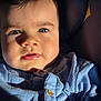 Rafaël a rejoint le concours — aidez-le/la à gagner de superbes lots ! baby, child, face, blue_eyes, blue_shirt, buttoned_shirt, close_up, portrait, sunlight, shadow, infant, young_child, skin, hair, expression, indoors, seat, clothing, person, cute