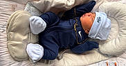 Izaiah joined the competition — help win amazing prizes! newborn, baby, sleeping, infant, portrait, bassinet, blanket, cushion, hat, knit_cap, navy_clothing, white_socks, gold_chain, nursery, bedding, soft_lighting, indoors, peaceful, resting, closeup