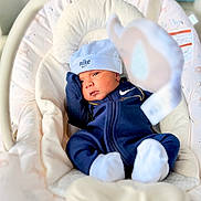 Izaiah joined the competition — help win amazing prizes! newborn, baby, infant, child, portrait, face, eyes_open, blue_outfit, tracksuit, hat, cap, nike, mittens, socks, baby_rocker, bouncer, blanket, cushion, indoor, cozy