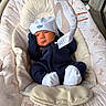 Izaiah is registered to the contest to win money with this photo: newborn, baby, infant, child, portrait, sleeping, hat, knit_hat, navy_outfit, white_socks, bouncer, baby_seat, plush, blanket, toy, nursery, indoor, seated, face, photography