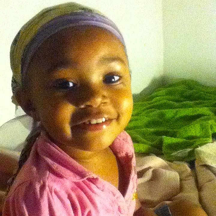 Ani joined the competition — help win amazing prizes! child, smile, headscarf, pink_clothing, indoor, bed, blanket, happy, face, person, portrait, young, cozy, casual, warm, home, seated, cute, skin, eyes