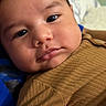 Jazer joined the competition — help win amazing prizes! baby, close_up, face, child, infant, cute, chubby_cheeks, portrait, skin, eyelashes, brown_clothing, texture, lying_down, soft_surface, curious, indoors, young_child, expression, person, head