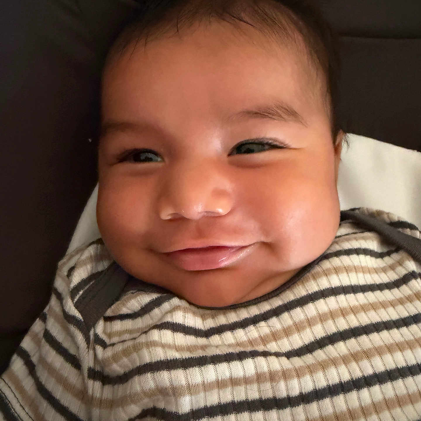 Jazer joined the competition — help win amazing prizes! baby, smile, face, striped_shirt, infant, closeup, child, cushion, happy, portrait, person, young_child, skin, head, eyes, cheeks, mouth, clothing, indoors, baby_fashion