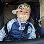 Maïlo participe au concours pour gagner de l'argent avec cette photo : baby, child, pacifier, stroller, cap, clothing, blue, white, striped, face, eyes, infant, seatbelt, sitting, cute, young, person, portrait, outdoor, babywearing
