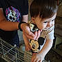 adult, animal, baby, bird, cage, chick, child, closeup, curious, cute, farm, hand, holding, indoor, interaction, mickey_mouse, person, rustic, shirt, toddler