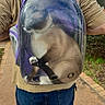 adventure, animal, astronaut_like, backpack, bubble_backpack, cat, clothing, fluffy, fur, greenery, lying_down, outdoor, pathway, paws, person, pet, pet_carrier, purple, transparent, travel