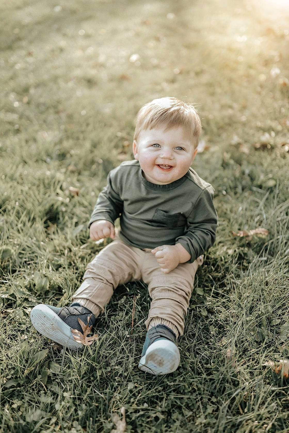 Benton joined the competition — help win amazing prizes! baby, baby_toddler_clothing, cheek, child, facial_expression, foot, grass, human, joy, laugh, outdoor_shoe, people_in_nature, person, photo_shoot, play, shoe, sitting, skin, sneakers, sock