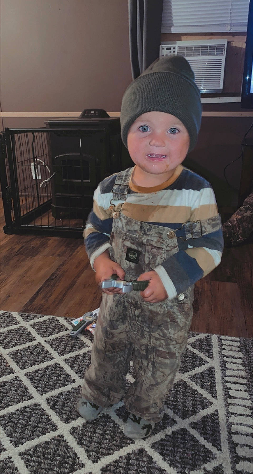 Benton is registered to the contest to win money with this photo: baby_toddler_clothing, camouflage, cap, child, flooring, fun, headgear, headwear, helmet, knit_cap, marines, military_camouflage, military_person, military_uniform, pattern, person, personal_protective_equipment, sleeve, soldier, toddler