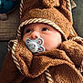 animal_print, baby, blanket, child, closeup, colorful, comfort, cute, face, hood, indoors, infant, pacifier, plush, portrait, resting, sleepy, soft, towel, toy