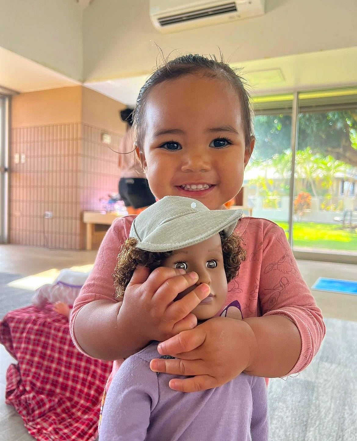 Melanie is registered to the contest to win money with this photo: arm, baby_toddler_clothing, child, elbow, event, finger, fun, gesture, hand, happy, hug, joy, leisure, person, shoulder, skin, smile, t_shirt, tartan, thumb