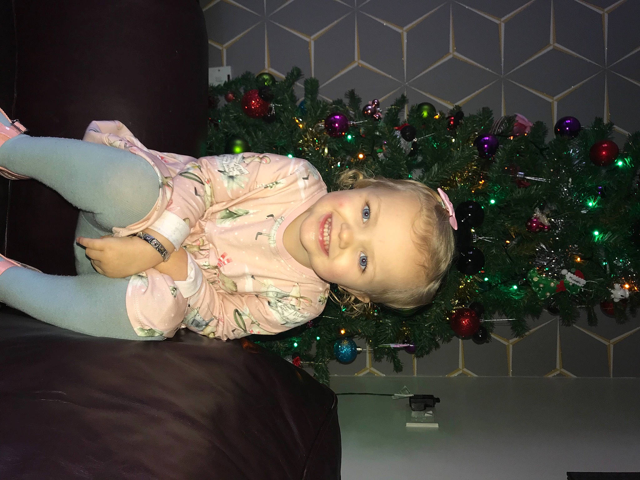 Lilly-rose is registered to the contest to win money with this photo: baby_toddler_clothing, christmas, christmas_decoration, christmas_eve, christmas_lights, christmas_ornament, christmas_tree, conifer, event, fir, green, holiday, holiday_ornament, home, human, interior_design, joy, ornament, person, pine_family