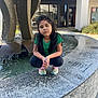 architecture, car, child, clothing, face, female, footwear, fountain, girl, head, pants, person, photography, portrait, shoe, sitting, slate, transportation, vehicle, water