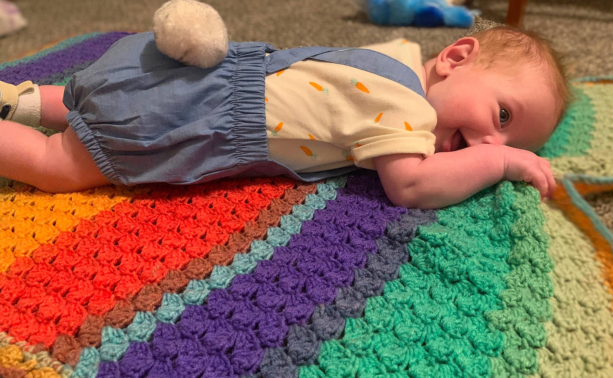 Dalton is registered to the contest to win money with this photo: baby, baby_toddler_clothing, blue, comfort, floor, flooring, fun, grass, green, human, joint, leaf, leisure, light, orange, people, person, red, textile, toddler