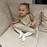 toddler, child, girl, couch, dress, sparkly, white_tights, pigtails, indoor, happy, smiling, seated, plush_furniture, beige, cute, young_child, portrait, fashion, home, cozy