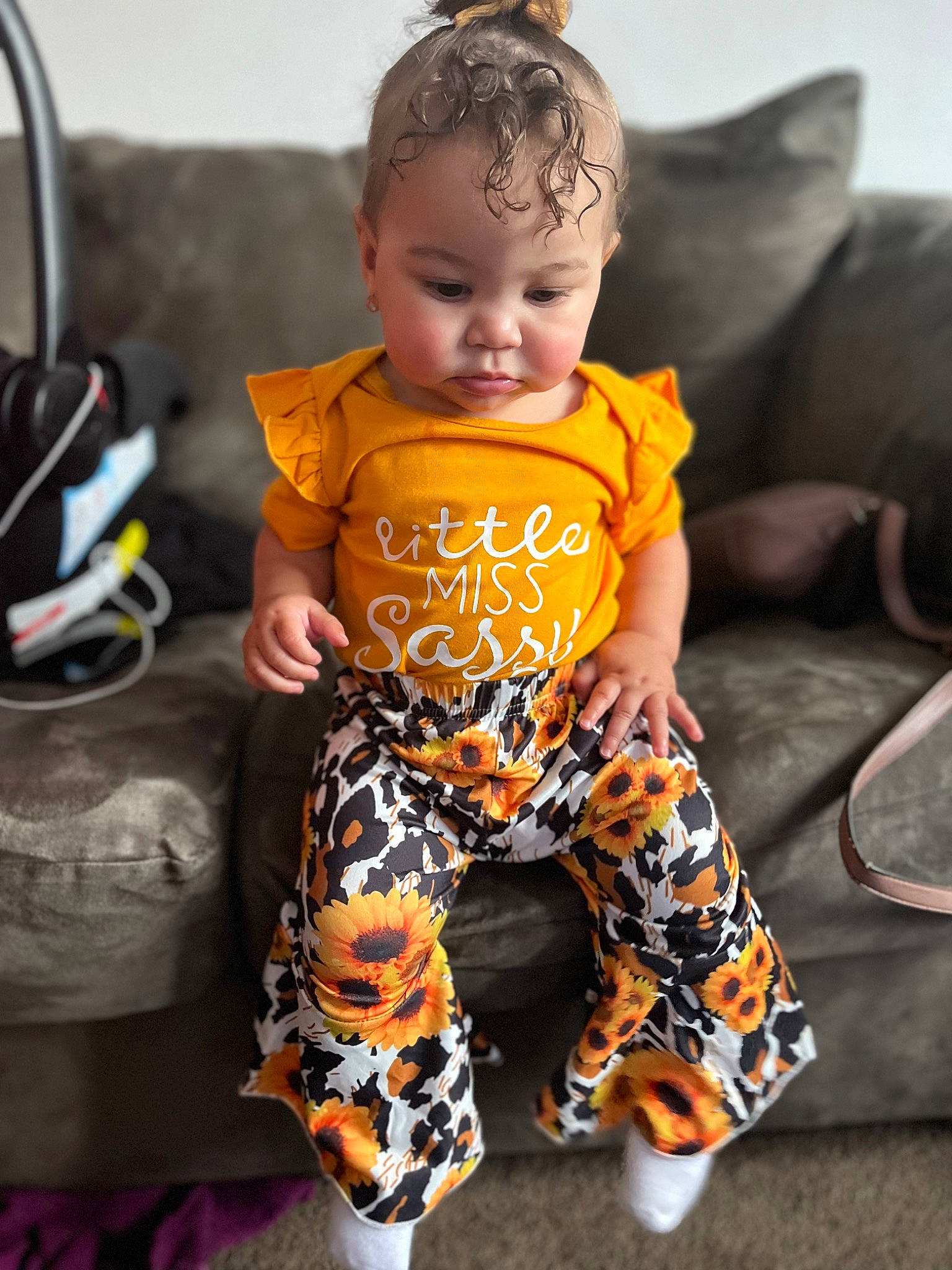 Leilani joined the competition — help win amazing prizes! baby, baby_toddler_clothing, child, couch, doll, eye, face, fashion_accessory, fashion_design, happy, head, jewellery, orange, pattern, person, personal_protective_equipment, sitting, sleeve, t_shirt, textile