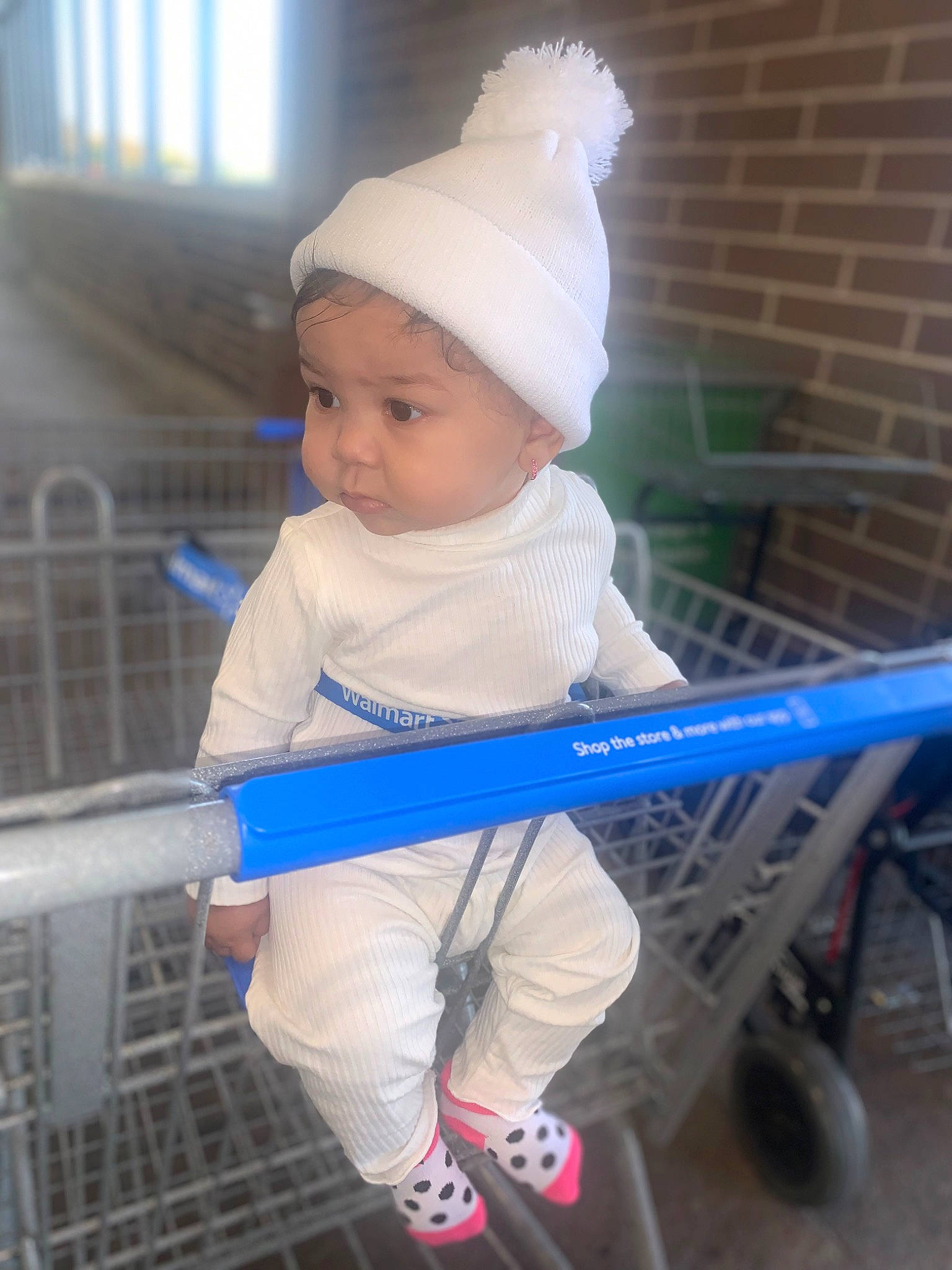 Leilani is registered to the contest to win money with this photo: baby, baby_carriage, baby_products, baby_safety, baby_toddler_clothing, beanie, cap, child, comfort, electric_blue, fun, headwear, helmet, human_leg, leisure, person, personal_protective_equipment, sitting, t_shirt, tire