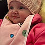 Freya is registered to the contest to win money with this photo: baby, child, pink_hat, knit_hat, pom_pom, bib, pink_clothing, cozy, cute, face, portrait, smile, indoor, warm_clothing, closeup, infant, soft_texture, happy, cheeks, young_child