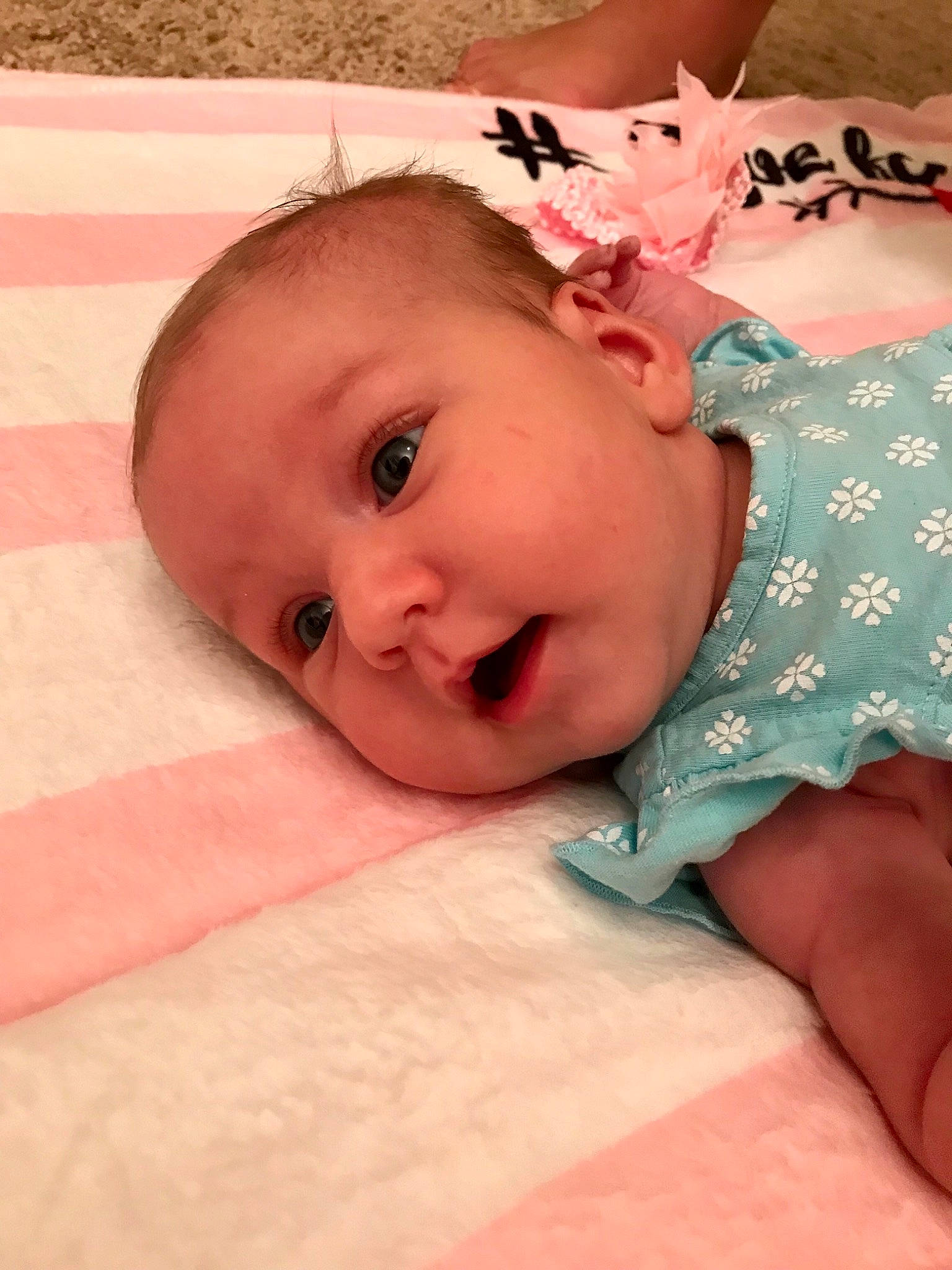 Natalya is registered to the contest to win money with this photo: baby, baby_toddler_clothing, cheek, child, close_up, eye, face, facial_expression, forehead, head, lip, mouth, nose, person, pink, skin, smile, toddler