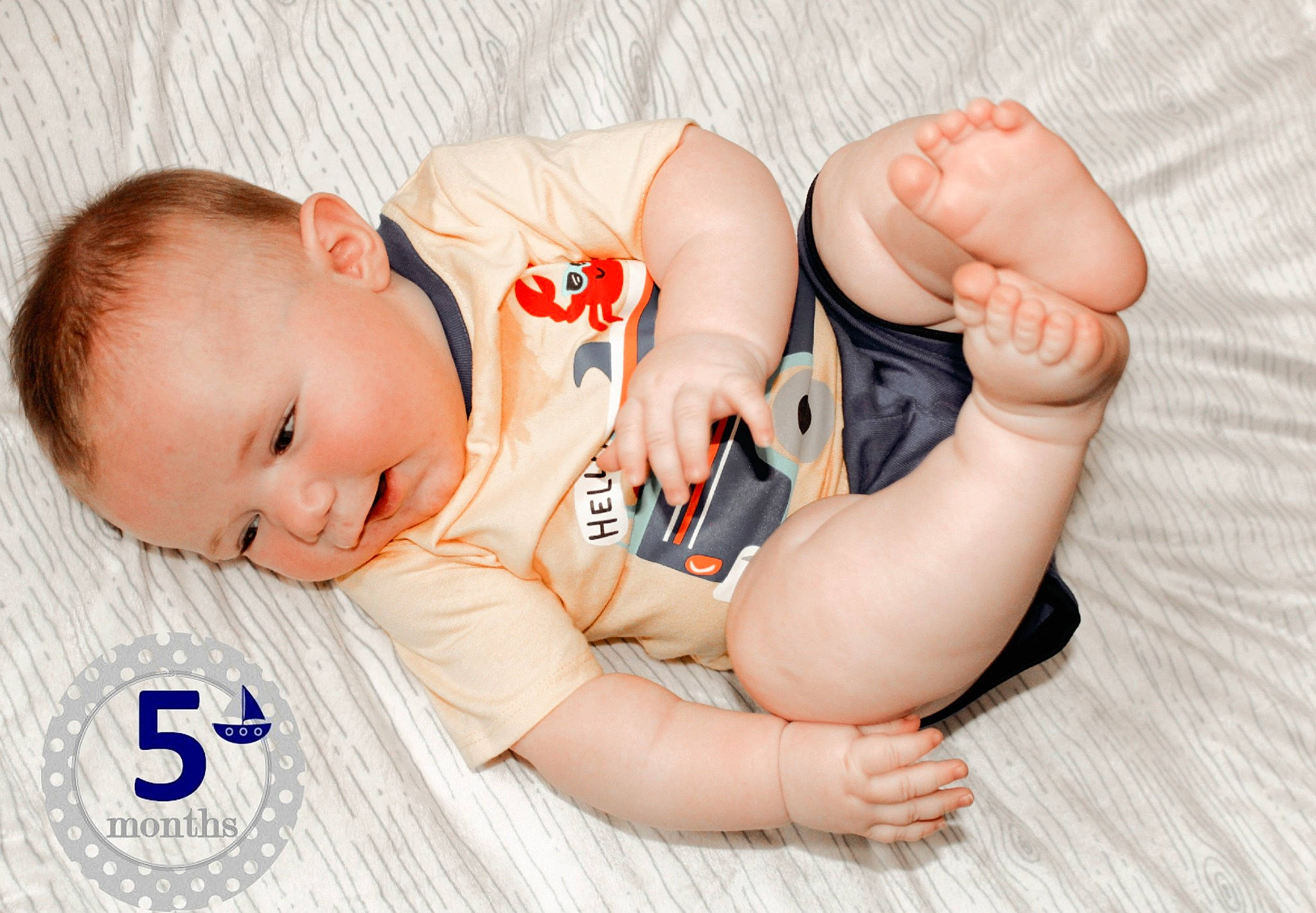 Wilson is registered to the contest to win money with this photo: arm, baby, baby_sleeping, baby_toddler_clothing, comfort, facial_expression, finger, gesture, hand, head, joint, mammal, muscle, neck, orange, person, skin, stomach, toddler, vertebrate