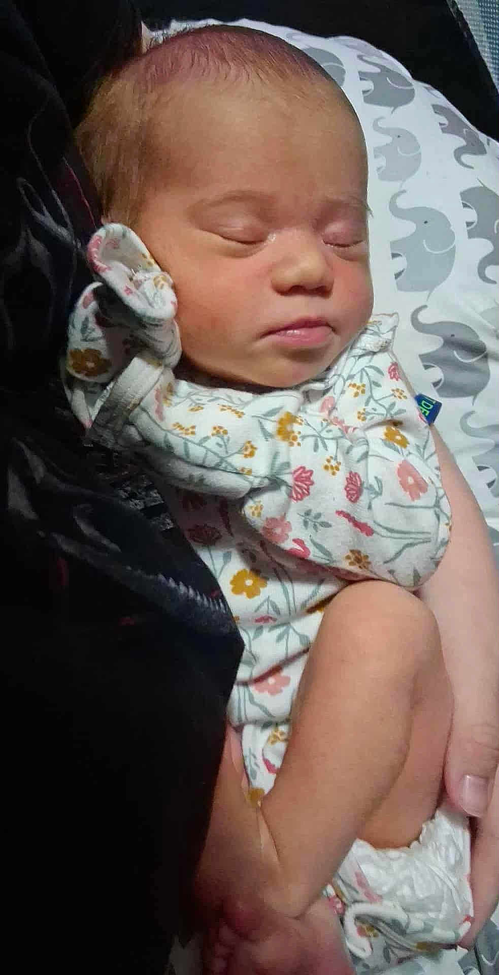 Chika is registered to the contest to win money with this photo: newborn, baby, sleeping, infant, person, arm, hand, clothing, onesie, floral_pattern, pillow, elephant_pattern, skin, closeup, indoors, rest, peaceful, soft, cute, toddler