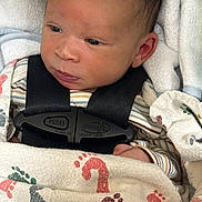 Eliza joined the competition — help win amazing prizes! baby, blanket, car_seat, child, closeup, clothing, cute, expression, face, footprint_pattern, harness, head, indoors, infant, newborn, portrait, resting, skin, striped_shirt, swaddled