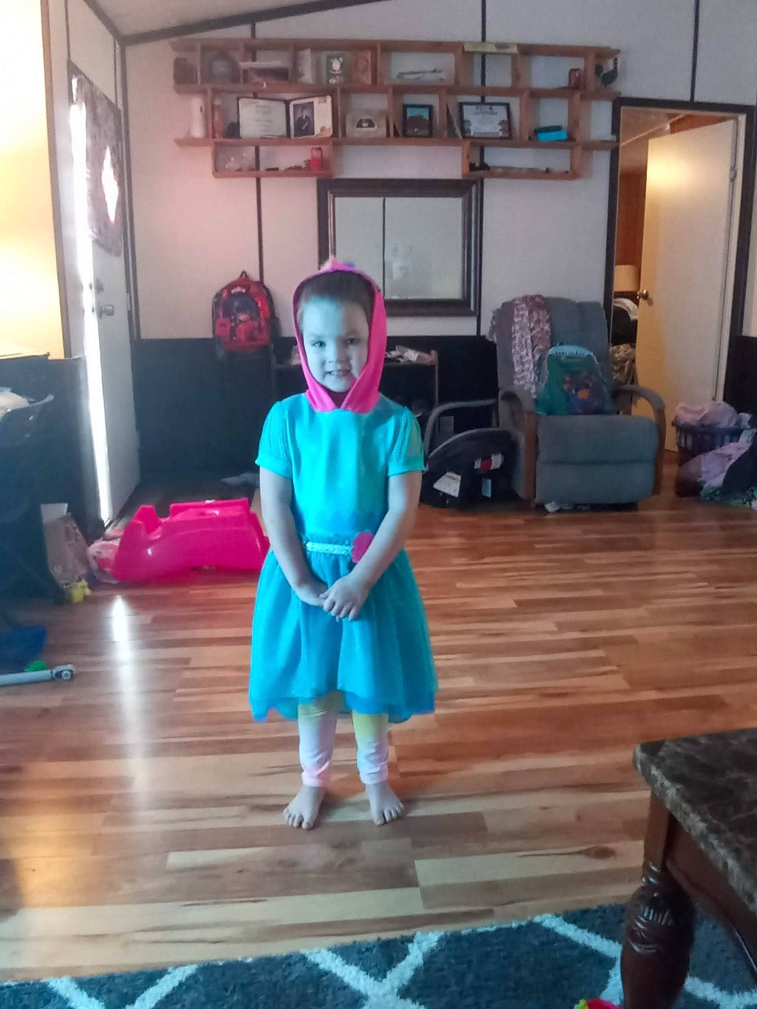 Hayzel is registered to the contest to win money with this photo: baby_toddler_clothing, child, dress, electric_blue, event, floor, flooring, fun, happy, hardwood, house, leisure, living_room, magenta, person, picture_frame, room, sitting, toddler, wood