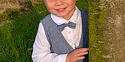 Axel participe au concours pour gagner de l'argent avec cette photo : child, boy, smiling, outdoor, tree, grass, vest, bow_tie, white_shirt, portrait, nature, happy, cute, young_child, blond_hair, casual, playful, greenery, person, fashion