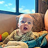 Wes is registered to the contest to win money with this photo: baby, blanket, blue_sky, child, comfort, couch, cozy, curious_expression, face, head, home, human, indoor, infant, natural_light, portrait, soft_texture, striped_clothing, window, young_child