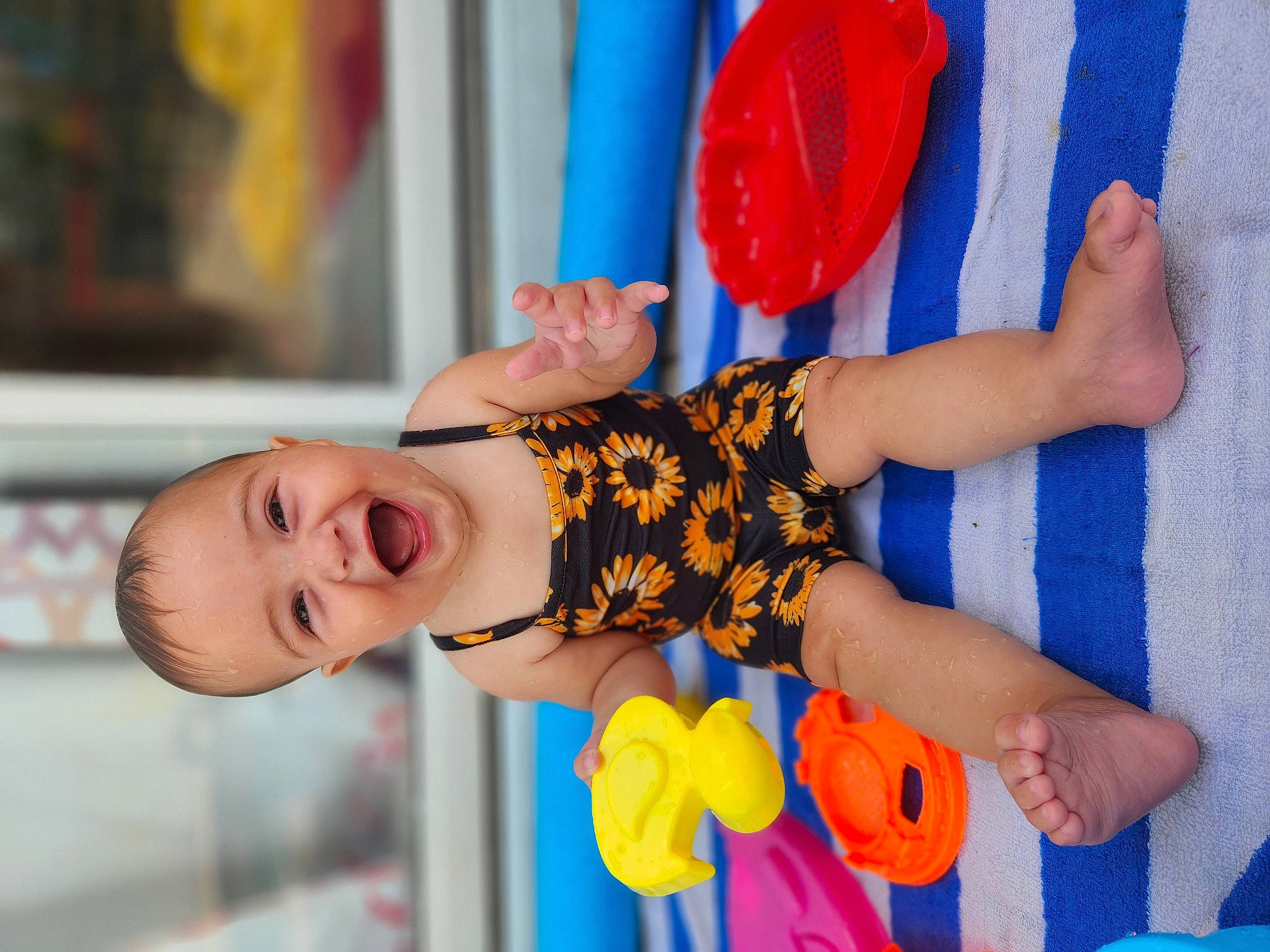 Paisley is registered to the contest to win money with this photo: baby, baby_products, baby_toddler_clothing, child, dress, electric_blue, finger, fun, gesture, hand, happy, nail, orange, pattern, person, play, smile, textile, toddler, toy