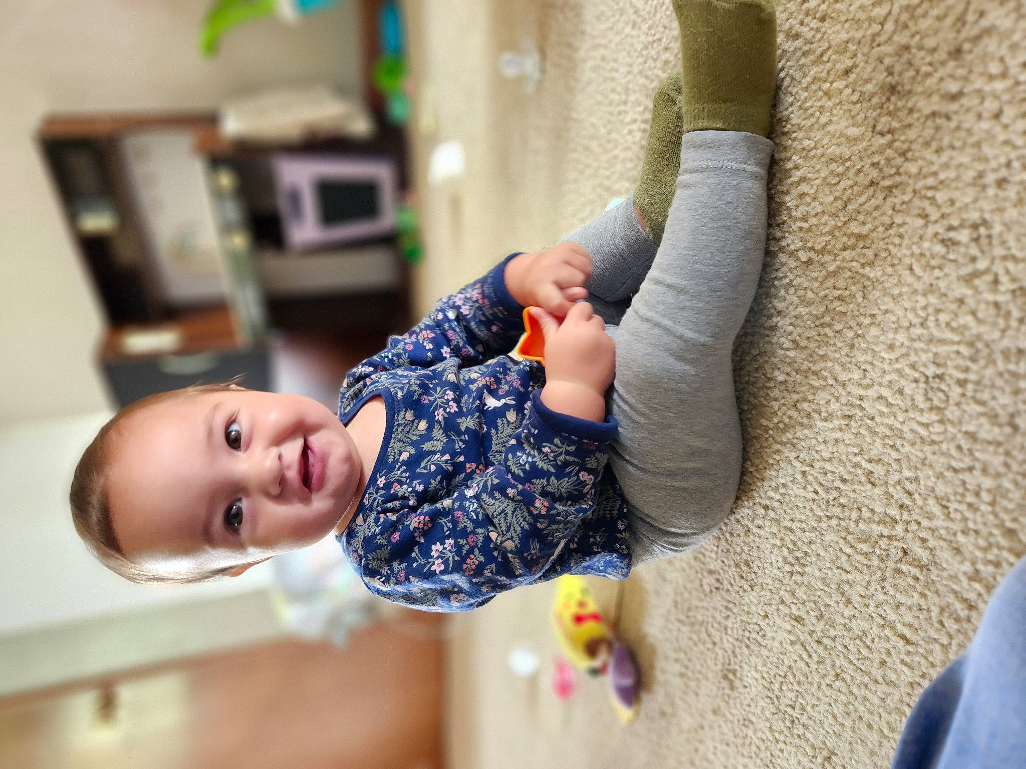 Paisley joined the competition — help win amazing prizes! baby, baby_toddler_clothing, child, comfort, finger, flooring, gesture, happy, human_body, human_leg, joint, joy, leisure, person, room, sitting, sleeve, smile, sock, toddler