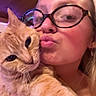 Momma Cat is registered to the contest to win money with this photo: affection, cat, close_up, cute, earrings, expression, face, feline, glasses, holding, indoor, light, orange_tabby, person, pet, pout, selfie, skin, whiskers, wood_ceiling