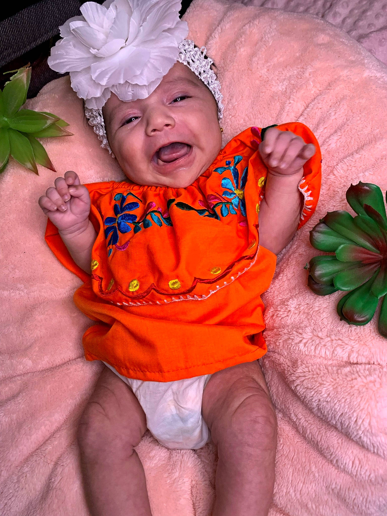 Catalina is registered to the contest to win money with this photo: baby, baby_toddler_clothing, child, comfort, face, fun, grass, green, happy, headwear, leaf, linens, pattern, peach, person, petal, pink, plant, skin, smile