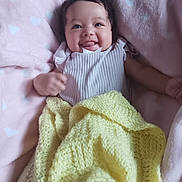 Avianna joined the competition — help win amazing prizes! baby, smiling, tongue_out, blanket, yellow_blanket, pink_blanket, heart_pattern, curly_hair, infant, happy, cozy, cute, lying_down, soft_texture, indoors, child, clothing, portrait, toddler, playful