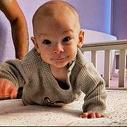 Levi joined the competition — help win amazing prizes! baby, child, crawling, sweater, bed, crib, nursery, indoor, person, face, smile, curious, knitwear, head, hand, furniture, room, soft_lighting, young, infant