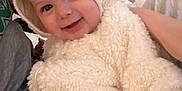 Vincent joined the competition — help win amazing prizes! baby, child, hoodie, fluffy_clothing, smile, cute, indoor, person, face, cozy, warm_clothing, sitting, candid, happy, infant, apparel, portrait, soft_texture, headwear, young_child