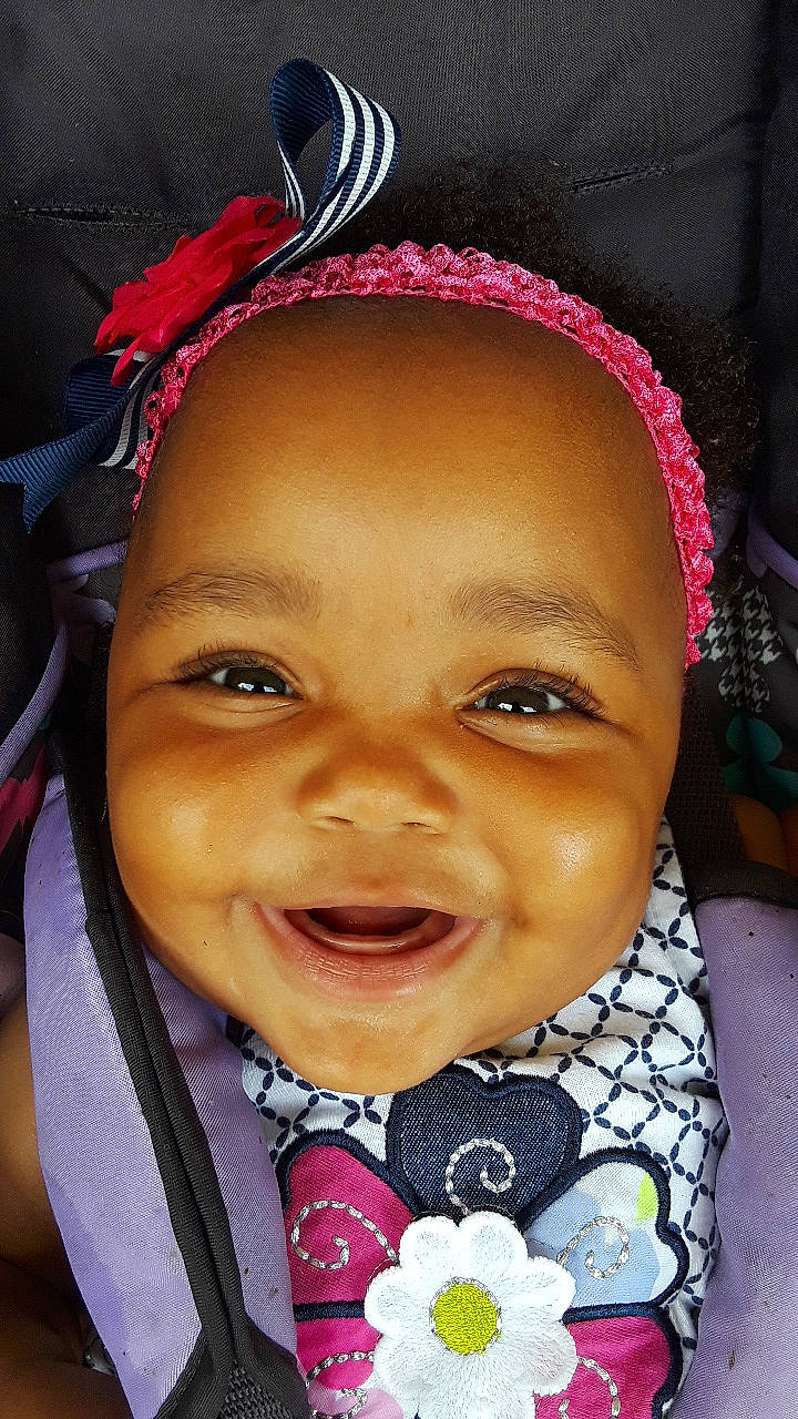 Kimora is registered to the contest to win money with this photo: cheek, child, chin, ear, eyebrow, face, facial_expression, fashion_accessory, forehead, hair_accessory, head, headgear, lip, mouth, nose, organ, people, person, skin, smile