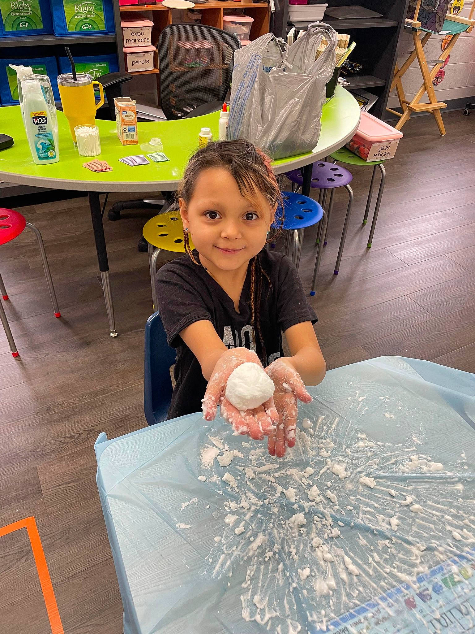 Maliah is registered to the contest to win money with this photo: chair, child, engineering, event, flooring, fun, furniture, glass, green, joy, leisure, person, plastic_bag, room, science, smile, t_shirt, table, toddler, visual_arts