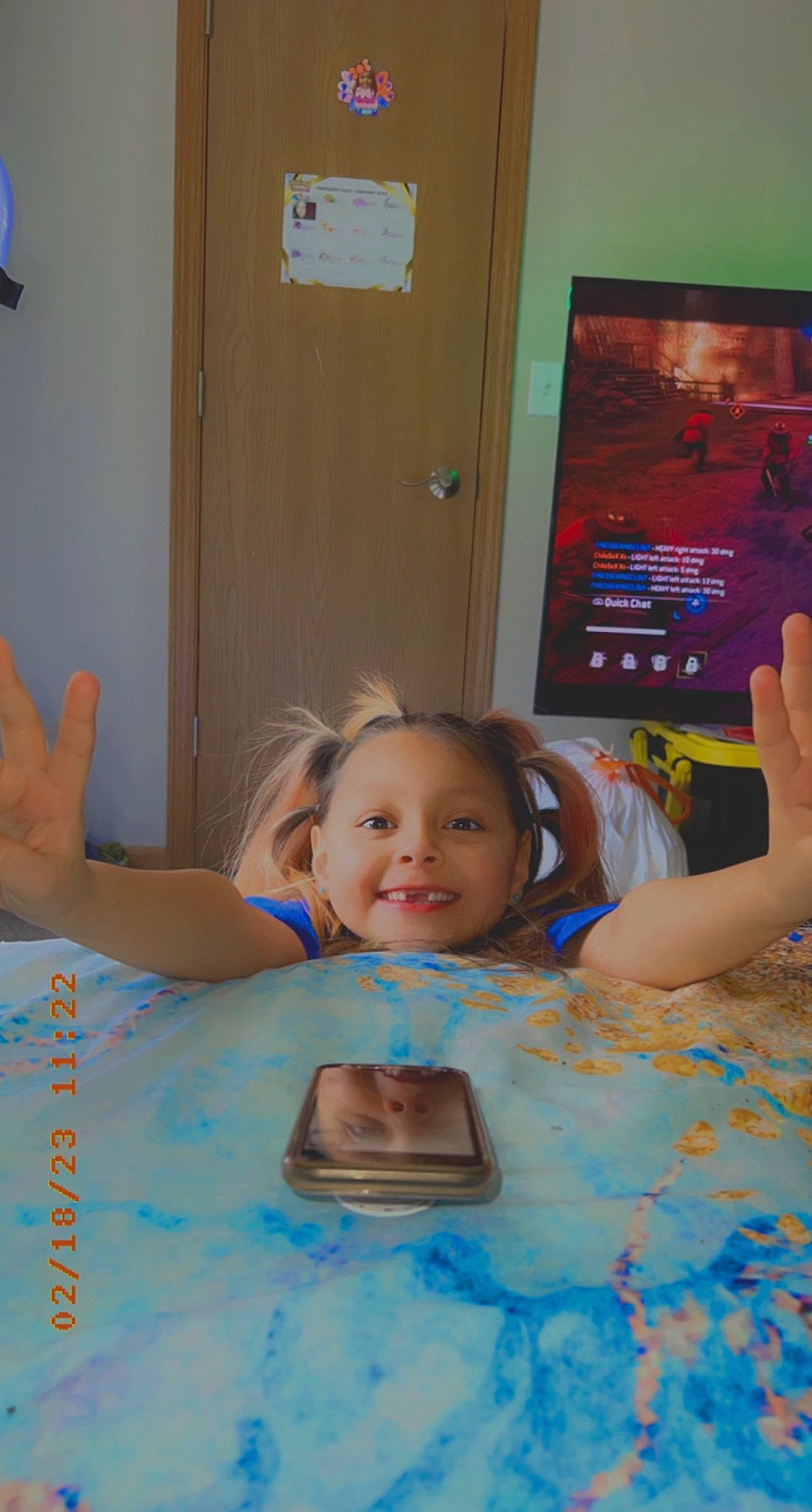 Maliah is registered to the contest to win money with this photo: bathing, blue, child, door, event, finger, flooring, fun, happy, joy, leisure, party, person, play, recreation, room, sitting, smile, t_shirt, table