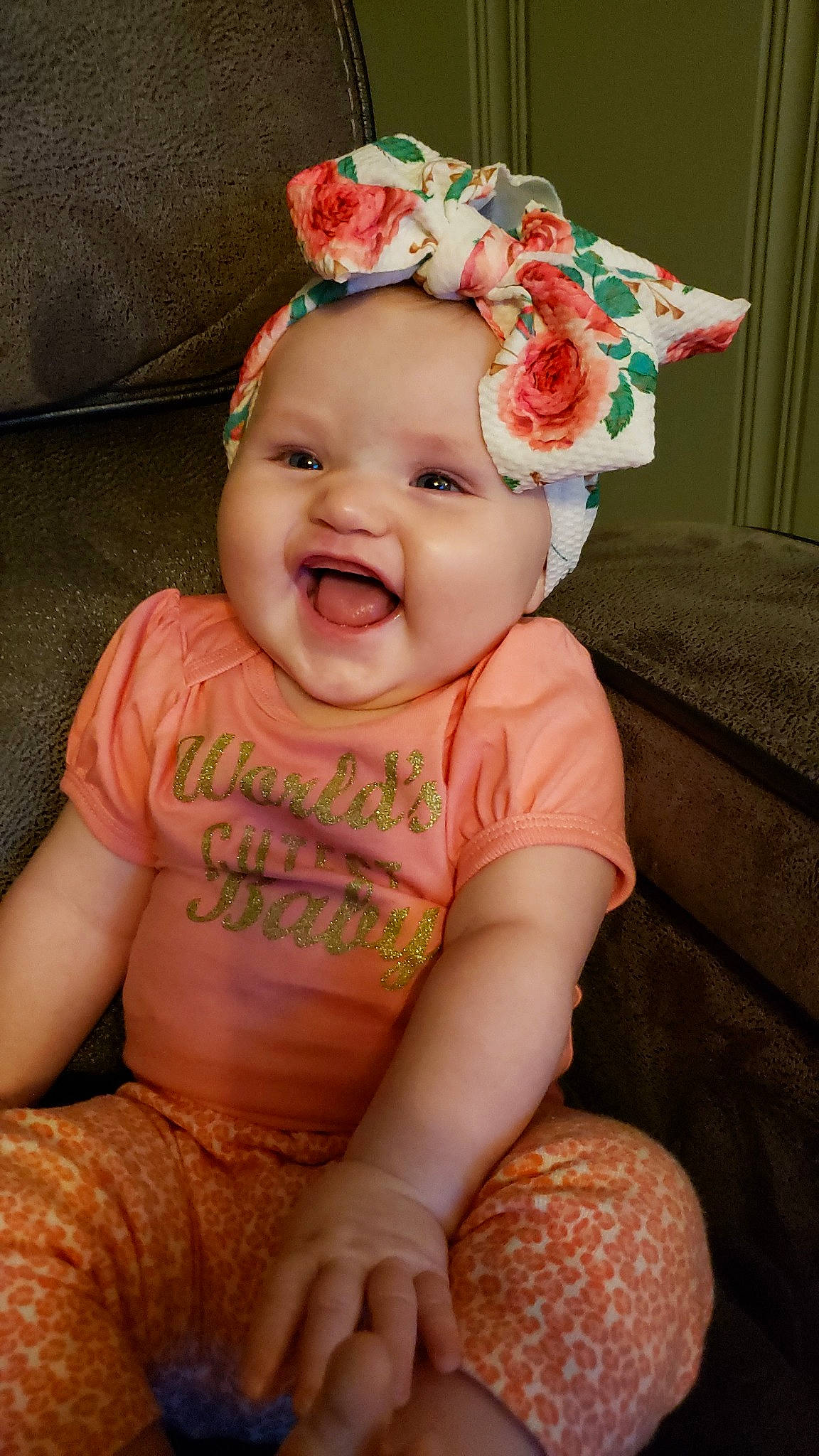 Selah is registered to the contest to win money with this photo: baby, baby_toddler_clothing, cheek, child, fashion_accessory, hair_accessory, hat, headgear, lip, person, pink, sitting, skin, smile, toddler