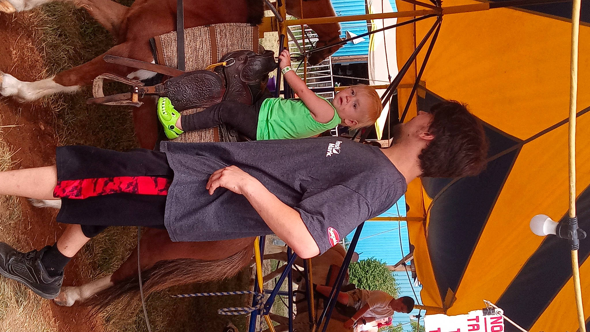 Christopher joined the competition — help win amazing prizes! bag, boot, chair, entertainment, event, fun, hat, human_leg, knee, lap, leisure, luggage_and_bags, music, musician, person, room, sandal, shorts, sitting, sock