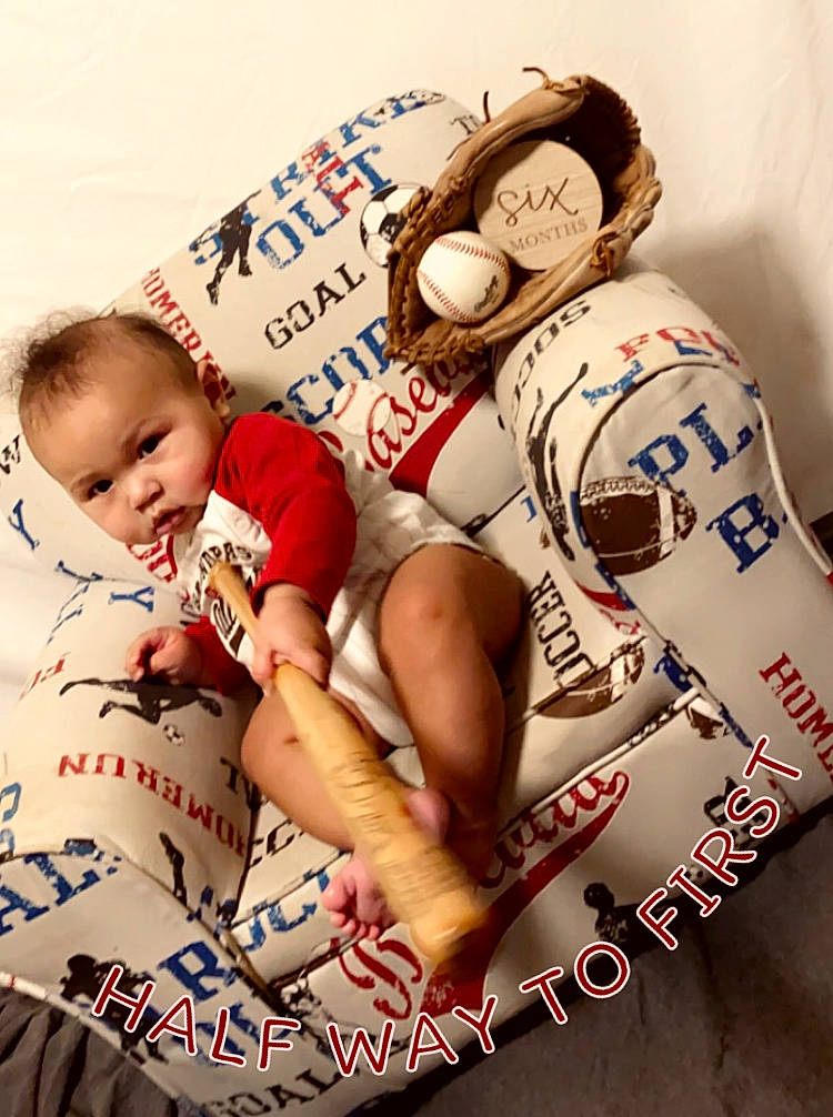 Donte is registered to the contest to win money with this photo: baby, bedding, carmine, chest, child, comfort, flesh, font, gesture, happy, human_leg, illustration, linens, pattern, person, pillow, t_shirt, thigh, throw_pillow, toddler