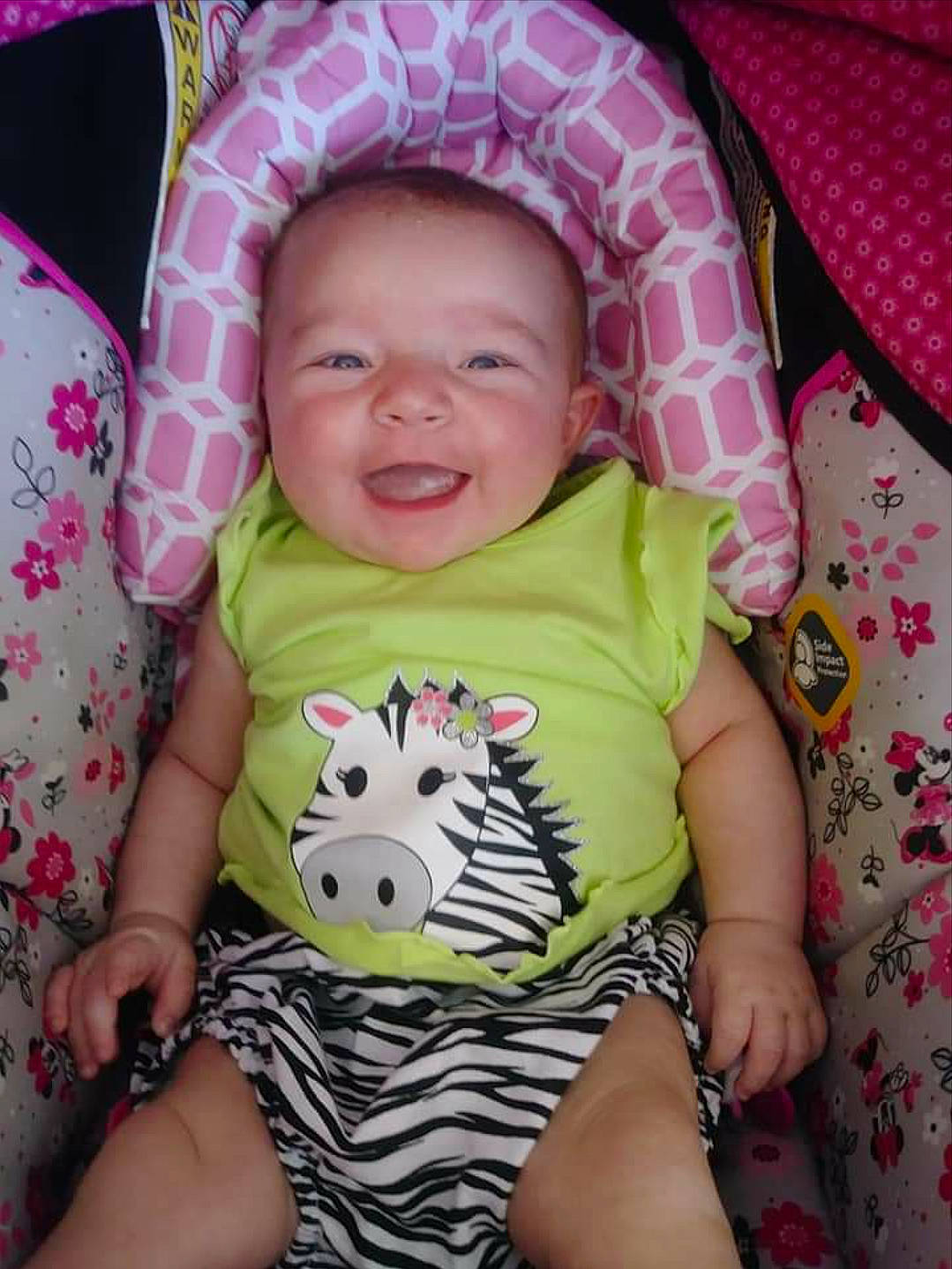 Alyson is registered to the contest to win money with this photo: baby_products, cheek, child, day, eye, face, facial_expression, girl, head, infant, iris, joy, mouth, person, pink, product, purple, skin, smile, textile